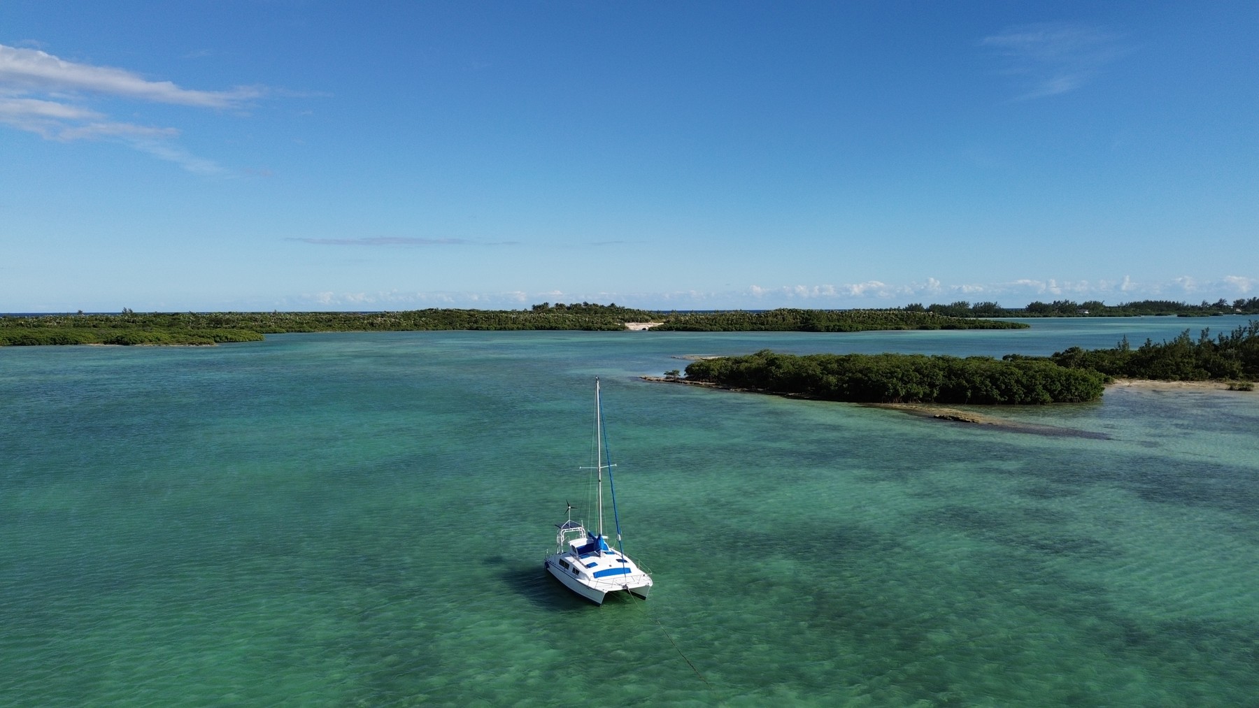 ESA’s accommodation catamaran anchored in the turquoise waters in front of the sailing school