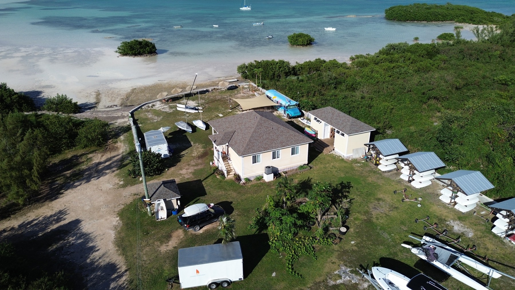 Aerial view of ESA with the sailing school on shore and the catamaran anchored just offshore